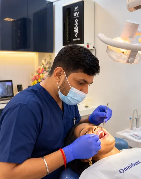 Dr. Shubham Tripathi examining a patient's teeth in the treatment room at Roots & Pulp Dental Clinic