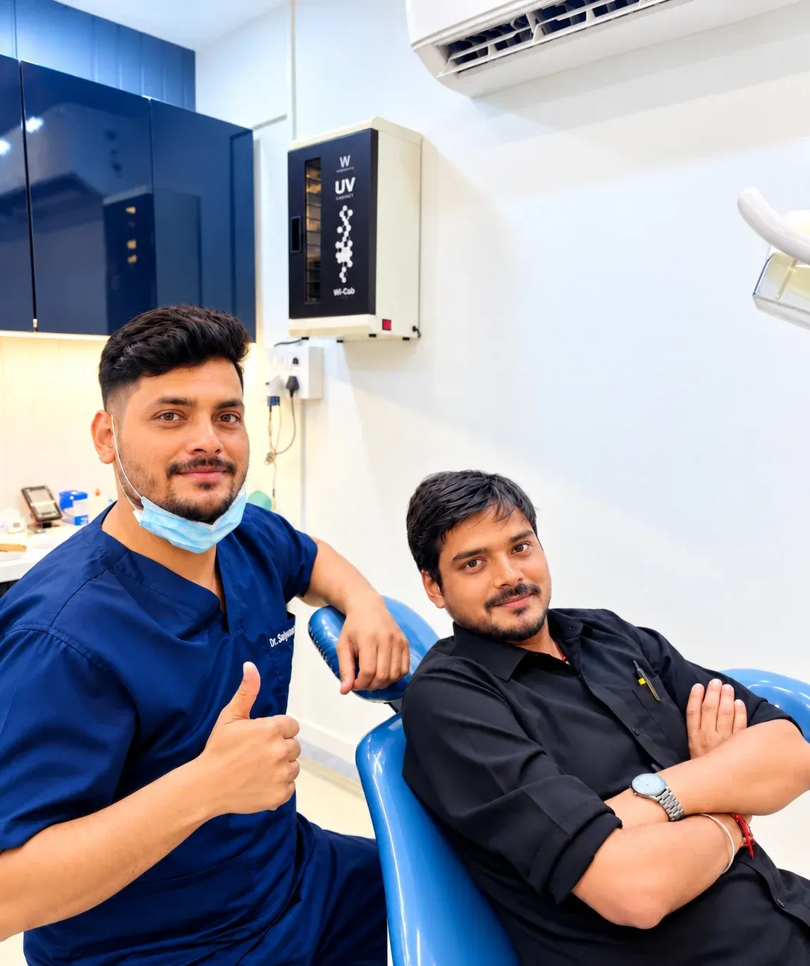 A Roots & Pulp dentist giving a thumbs up beside a patient in the treatment chair