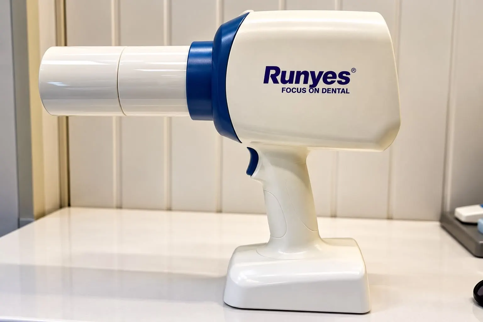 Handheld portable dental X-ray unit on its stand